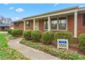 Attractive brick home, with manicured hedges, and a walkway leading to the front door at 709 S Sellars Mill Rd, Burlington, NC 27217