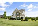 Lovely two-story home with stone accents, shutters, and a lush green lawn at 71 Del Corso Ct, Clayton, NC 27527