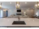 Open-concept kitchen with island seating overlooking the cozy living area with a fireplace at 717 Penn Rd, Raleigh, NC 27604