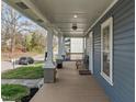Spacious covered porch with wood flooring offering a comfortable outdoor living area at 908 Spruce St, Durham, NC 27701