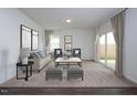 Inviting living room with neutral tones, comfortable seating, and sliding doors that allow natural light at 100 Big Dream Ct, Louisburg, NC 27549