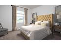 Serene bedroom with a tufted headboard, cozy bedding, and soft lighting for a relaxing atmosphere at 100 Big Dream Ct, Louisburg, NC 27549