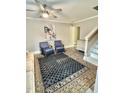 Comfortable living room with a stylish rug, ceiling fan, and neutral color palette at 120 Johnson St, Roxboro, NC 27573