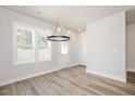 Dining area featuring wood floors, recessed lighting, a modern chandelier, and windows with a view at 123 Weavers Grove Dr, Chapel Hill, NC 27514