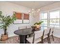 Staged dining room with an oval table, six chairs, modern lighting and ample natural light at 123 Weavers Grv Dr, Chapel Hill, NC 27514