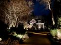 Beautifully illuminated home at night with manicured landscaping and a welcoming driveway at 1616 Kirkby Ln, Raleigh, NC 27614