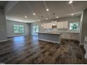 Open kitchen with modern cabinetry, a large center island, and dark wood flooring throughout the home at 1684 Pecan Drive # 43, Nashville, NC 27856