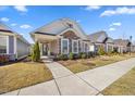 Inviting single-story home showcasing stone accents, light siding, and a well-maintained front yard at 212 Thunder Forest Ln, Wendell, NC 27591