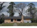 Single-story house featuring stone accents, a front yard, and a gray roof on a sunny day at 2602 Fayetteville St, Durham, NC 27707