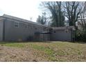 View of the house's exterior from the backyard, featuring the gray siding and a small covered patio at 2602 Fayetteville St, Durham, NC 27707