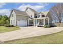 Charming two-story home featuring a spacious front yard, attached garage, and welcoming covered porch at 288 Joseph Alexander Dr, Fuquay Varina, NC 27526