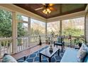 Relaxing screened porch with comfortable seating, plants, and a ceiling fan for outdoor enjoyment at 321 Weycroft Grant Dr, Cary, NC 27519