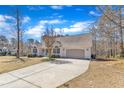 Single-Gathering home on a large lot features a long concrete driveway to the attached two car garage at 34 Triton Ct, Clayton, NC 27520