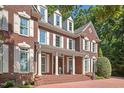 Stately brick residence with white columns, decorative lion statues, and meticulously maintained landscaping at 405 Silver Creek Trl, Chapel Hill, NC 27514