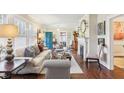 Cozy living room featuring hardwood floors, neutral furniture, and a decorative fireplace, offering a warm ambiance at 411 Circle Dr, Burlington, NC 27215