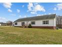 Exterior view of home with front lawn, wooden porch, and well maintained siding at 4194 Abattoir Rd, Angier, NC 27501