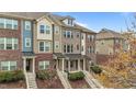 Brick and siding townhomes present an attractive facade with well-maintained landscaping at 556 Village Loop Dr, Apex, NC 27502