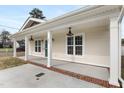 Inviting front porch with brick skirting, sturdy columns, and stylish lighting fixture, perfect for relaxing outdoors at 600 Cuddington Ln, Nashville, NC 27856