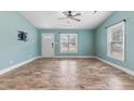 Bright living room with light blue walls, laminate floor, large window, and direct access to the front door at 600 Cuddington Ln, Nashville, NC 27856