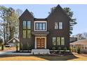Beautiful modern home featuring a dark exterior, large windows and a striking roofline at 604 Edmund St, Raleigh, NC 27604