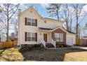 Charming two-story home with a well-manicured lawn and attached garage, perfect for suburban living at 605 Wyndham Dr, Fuquay Varina, NC 27526