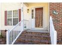 Inviting front entrance with brick accents and stairs leading to a warm and welcoming home at 605 Wyndham Dr, Fuquay Varina, NC 27526