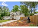 Charming two-story home featuring a landscaped yard, brick accents, and an attached garage at 605 Wyndham Dr, Fuquay Varina, NC 27526