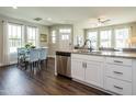 Open-concept kitchen and dining area featuring granite countertops, stainless steel appliances, and hardwood floors at 6405 Granite Quarry Dr, Raleigh, NC 27610
