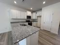 Kitchen features granite countertops, stainless steel appliances, and white cabinetry at 6405 Granite Quarry Dr, Raleigh, NC 27610