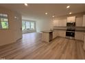 Open-concept kitchen features stainless appliances, granite countertops, and an island with a sink at 6405 Granite Quarry Dr, Raleigh, NC 27610