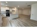 Bright kitchen featuring white cabinets, stainless steel appliances, and a center island with granite countertops at 6407 Granite Quarry Dr, Raleigh, NC 27610