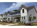 New townhomes boast multiple stories, large windows, modern siding and well-maintained lawns at 6411 Granite Quarry Dr, Raleigh, NC 27610