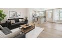 Open-concept living room with hardwood floors connecting to a modern kitchen, great for entertaining at 6411 Granite Quarry Dr, Raleigh, NC 27610