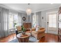 Bright living room featuring hardwood floors, comfortable seating, and ample natural light, perfect for relaxation at 711 S East Street St, Raleigh, NC 27601