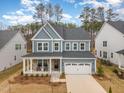 Beautiful two-story home with a covered porch, 2-car garage, well-maintained landscaping, and a welcoming entrance at 724 Red Arrow Dr, Knightdale, NC 27545
