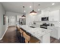 A gourmet kitchen featuring a large center island with bar seating and modern stainless-steel appliances at 752 Ben Ledi Ct, Raleigh, NC 27603