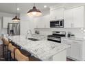 Well-appointed kitchen with a large island, modern stainless steel appliances, and ample counter space at 752 Ben Ledi Ct, Raleigh, NC 27603