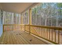 Back porch with natural wood and railings, overlooks wooded area at 0 Jasmine Rd, Fuquay Varina, NC 27526