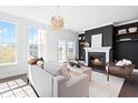 Inviting living room with a cozy fireplace, large windows, and a sliding glass door to the outside at 10210 Sablewood Drive # 112, Raleigh, NC 27617