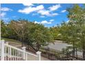 From the top of townhouse steps: View of a sidewalk, manicured foliage, and a street lined with mature trees at 10210 Sablewood Drive # 112, Raleigh, NC 27617