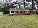 Traditional home with a well-maintained lawn at 103 Beam Cir, Louisburg, NC 27549