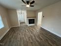 Bright living room featuring luxury vinyl plank flooring and a cozy fireplace at 103 Beam Cir, Louisburg, NC 27549