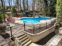 Scenic pool view with stairs leading to a private backyard oasis at 10540 Byrum Woods Dr, Raleigh, NC 27613