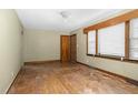 Bright living room with hardwood floors, large windows, and vintage wood trim at 1101 Nashville Rd, Rocky Mount, NC 27803