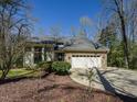 Charming home featuring a brick facade, a two-car garage and a well-manicured lawn at 114 Twin Springs Ln, Angier, NC 27501