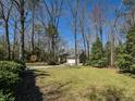A well-maintained front lawn and a charming single-Gathering home nestled in a tranquil, wooded setting at 114 Twin Springs Ln, Angier, NC 27501