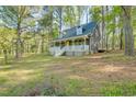 Charming exterior view of home featuring a welcoming front porch and well-maintained lawn at 1301 Flying Hawk Rd, Apex, NC 27523