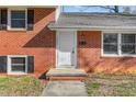 Close up of a home's front entrance showing a classic white door and brick facade at 1506 N Mebane St, Burlington, NC 27217