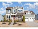 Inviting two-story home boasting stone accents, a cozy front porch, and an attached two-car garage at 1515 Spring Overlook Ln, Hillsborough, NC 27278