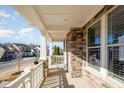 Spacious front porch showcasing stone accents, elegant columns, and a neighborhood view at 1515 Spring Overlook Ln, Hillsborough, NC 27278
